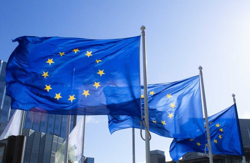 Foto com bandeiras da União Europeia no mastro. Representa bolsas da Europa